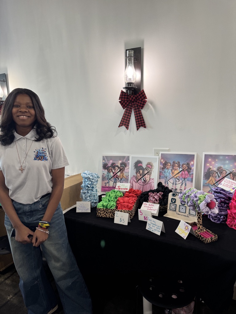Haley beside her handmade products at a vendor event