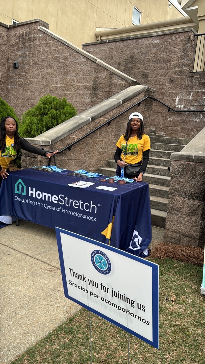 Volunteering behind a HomeStretch event table