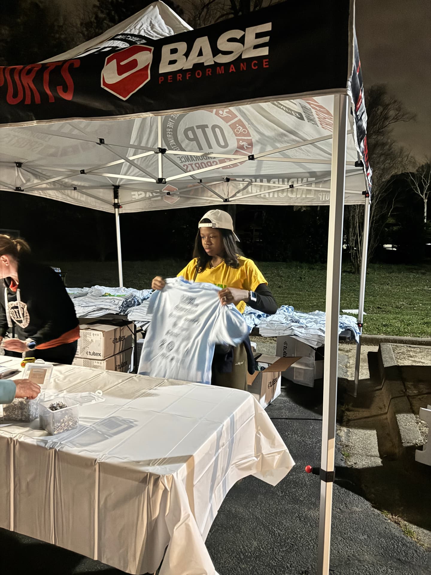 Organizing event shirts at a HomeStretch volunteer station